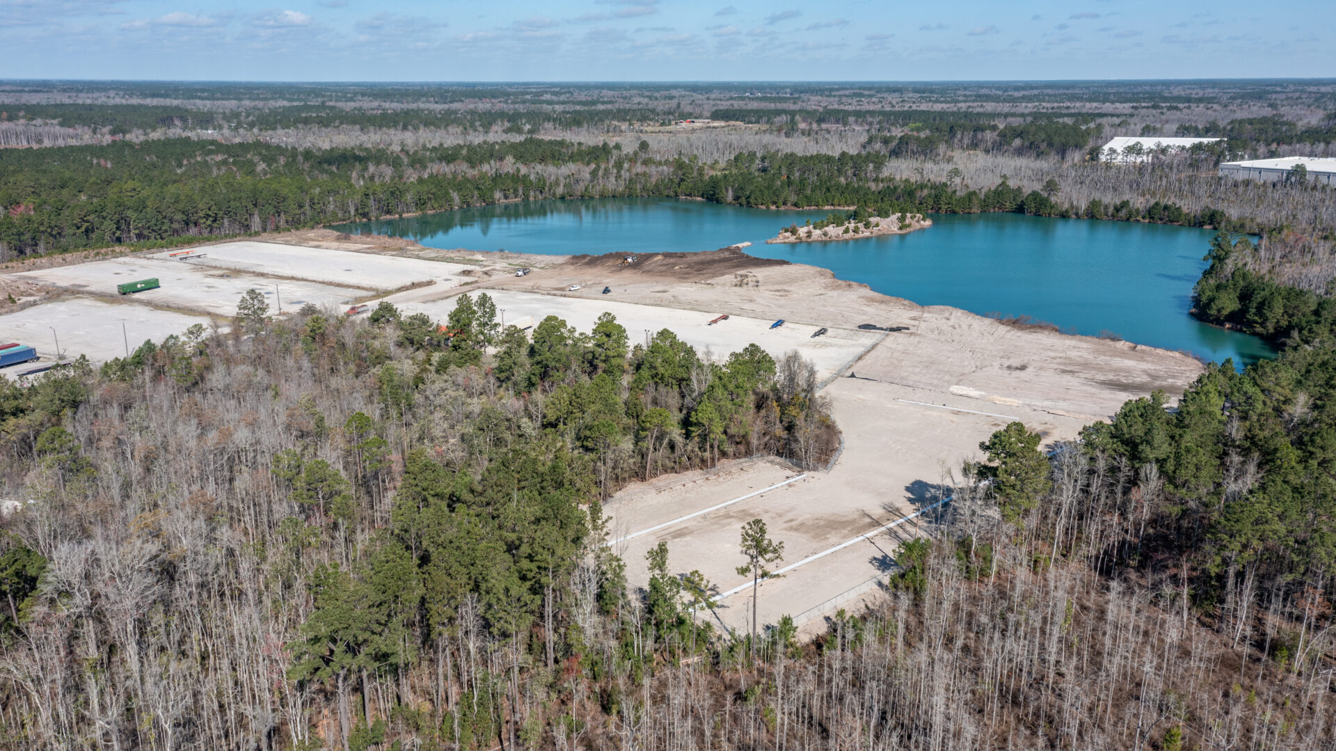 A view of the water from above shows trees and sand.