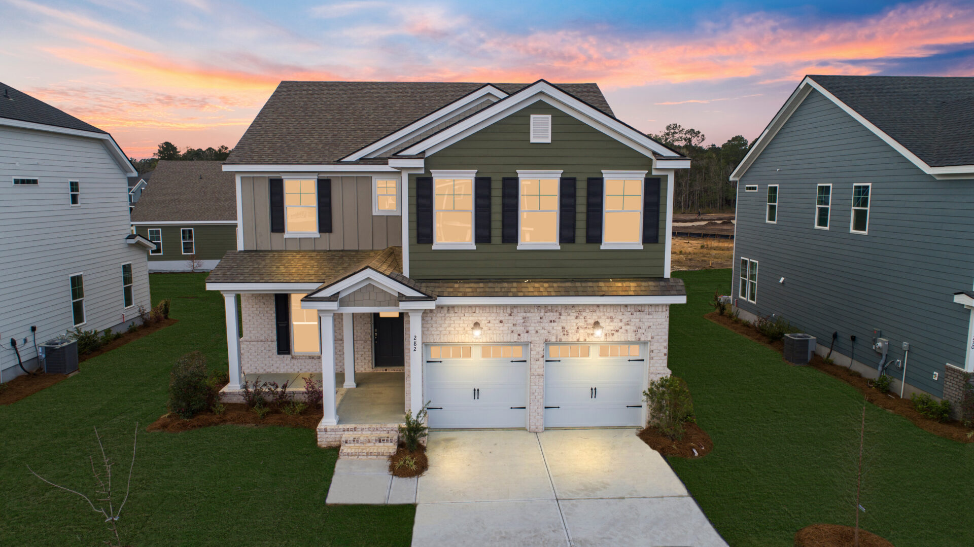 A house with two garage doors and a driveway.