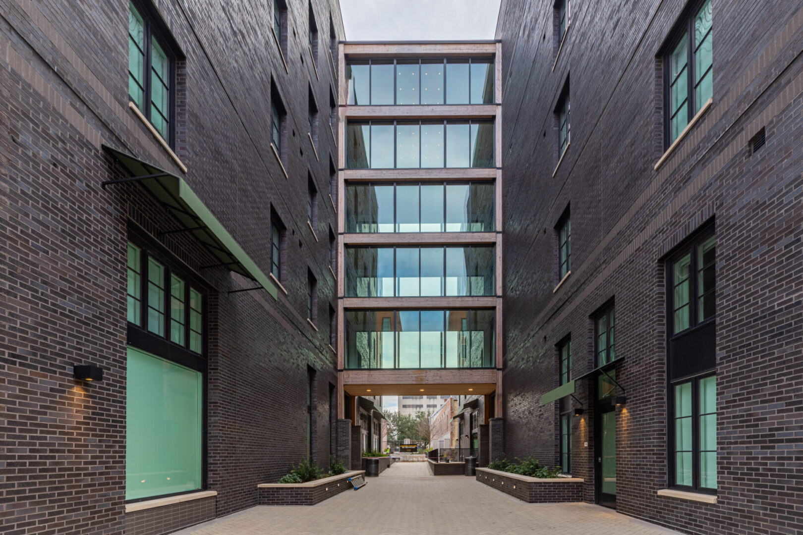 A building with many windows and doors on the side of it.