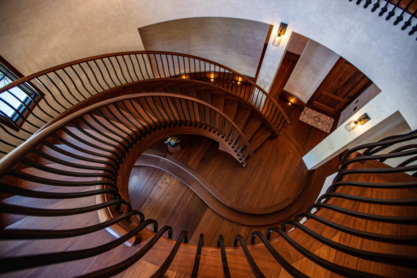 A spiral staircase with wooden steps and handrails.