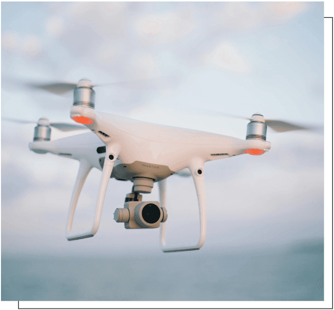 A white and red camera flying in the air.