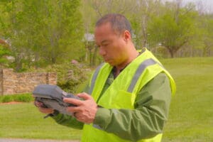 Professional certified drone equipment used for drone services including aerial surveying, FLIR thermal imaging, and photogrammetry data collection. Behind the scenes, corporate photography
