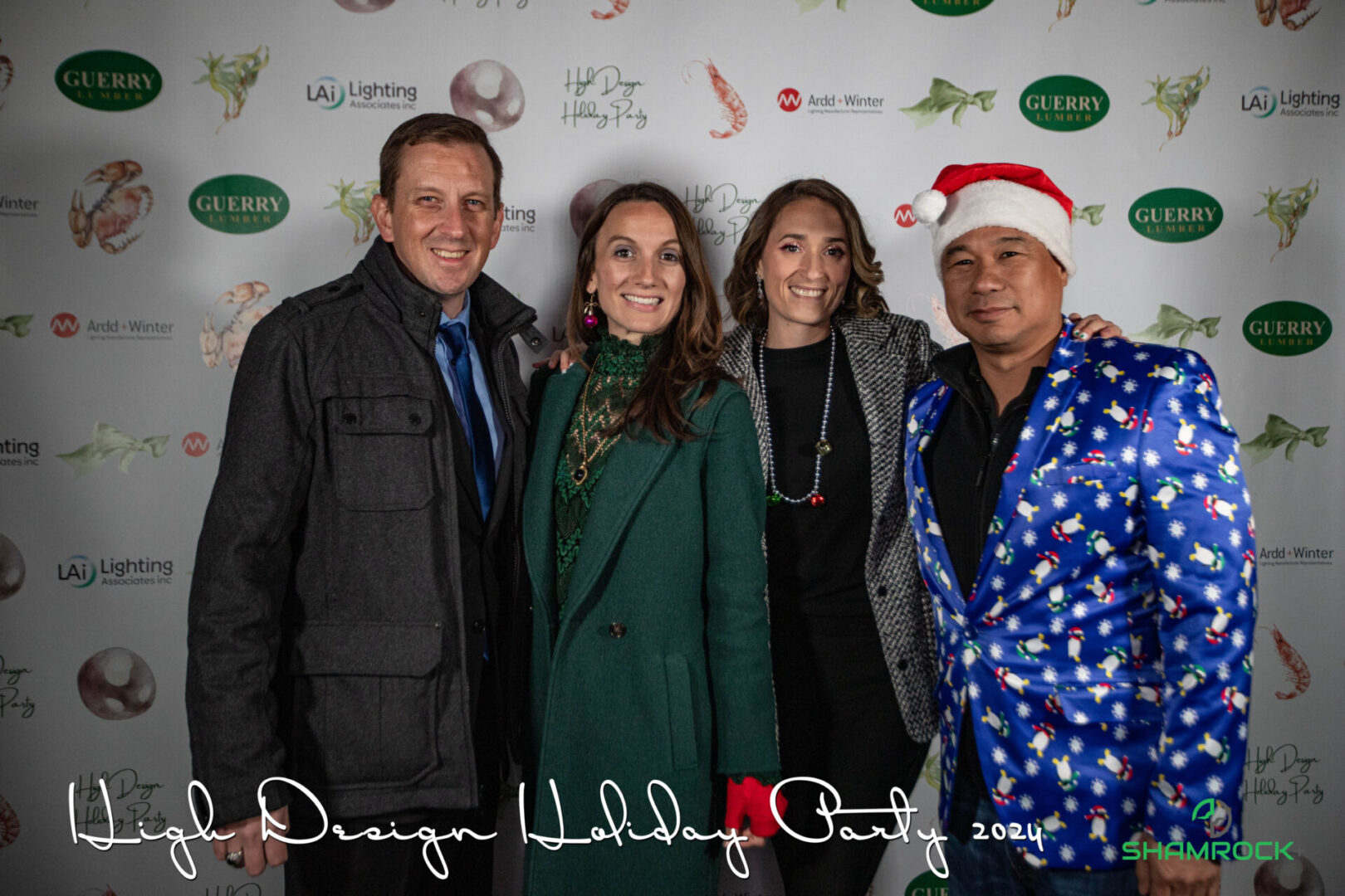 Professional event photographer capturing a corporate event with branded signage and guest engagement moments. Shamrock+ staff, holiday party, event coverage