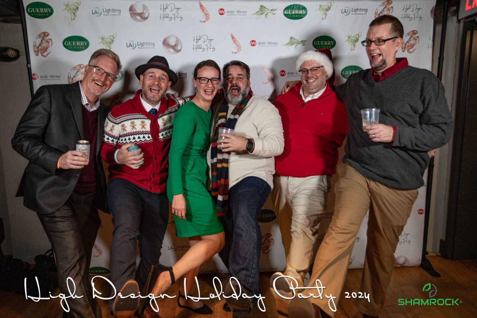 Professional event photographer capturing a corporate event with branded signage and guest engagement moments.