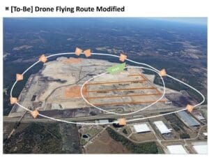 Aerial drone flying a pre-planned route to collect surveying data and support professional drone services for construction and land development.