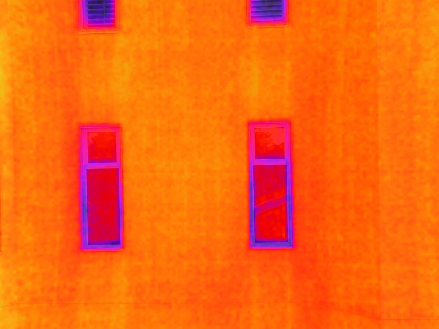 Drone performing FLIR thermal imaging inspection for aerial diagnostics and building analysis during professional drone services.