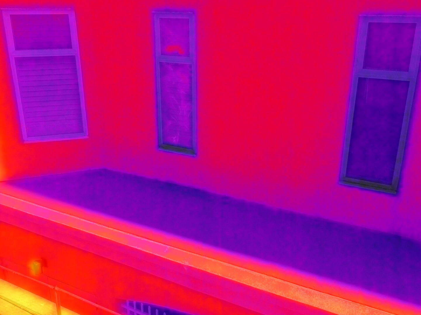 Drone performing FLIR thermal imaging inspection for aerial diagnostics and building analysis during professional drone services.