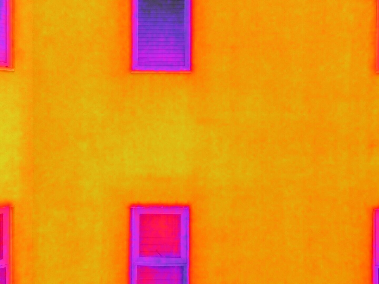 Drone performing FLIR thermal imaging inspection for aerial diagnostics and building analysis during professional drone services.