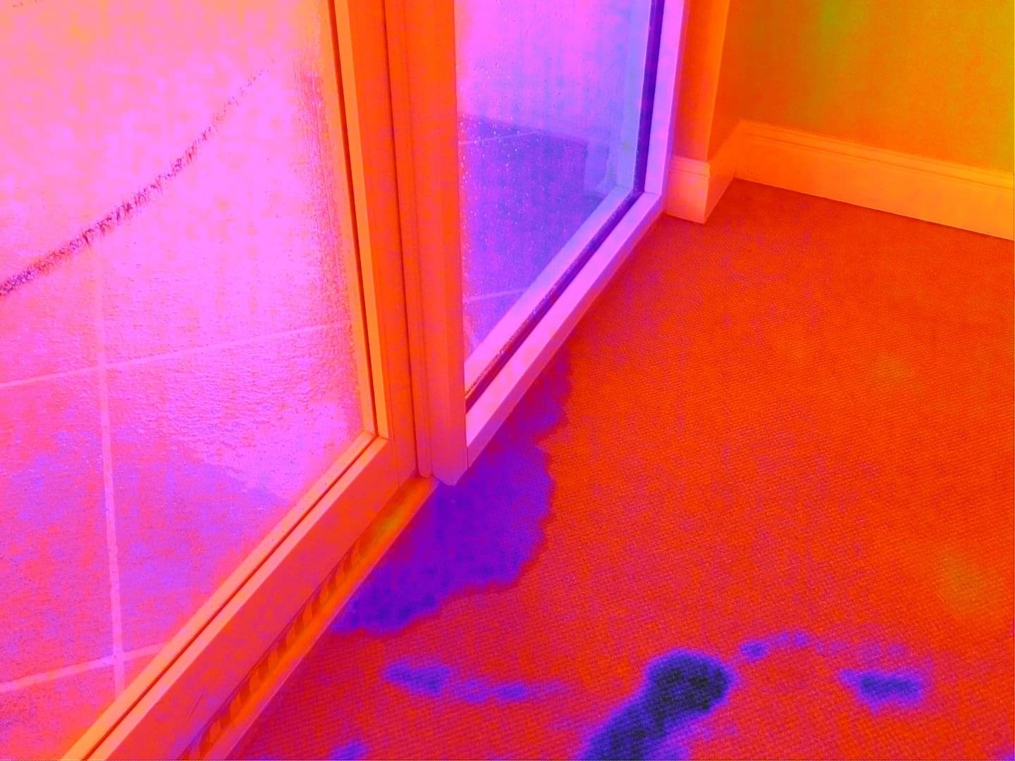 FLIR thermal imaging scan detecting water penetration inside a building during interior drone inspection.