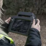 On-site photography of corporate team members working during an active project engagement in the field. behind the scenes