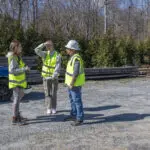 On-site photography of corporate team members working during an active project engagement in the field.
